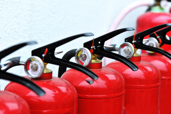 Red fire extinguishers in a line